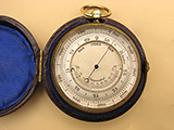 Late 19th century pocket barometer with curved thermometer in outer case